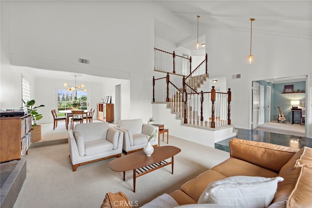 carpeted living area featuring visible vents, high vaulted ceiling, a notable chandelier, and stairway