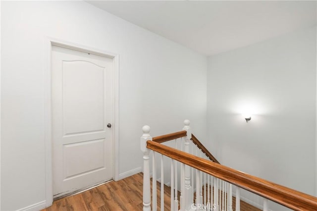 6651 Darling Ln, San Bernardino, CA 92407 - corridor featuring wood finished floors, an upstairs landing, and baseboards