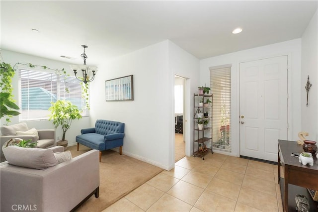 6651 Darling Ln, San Bernardino, CA 92407 - entryway with baseboards, light tile patterned floors, visible vents, a chandelier, and light carpet