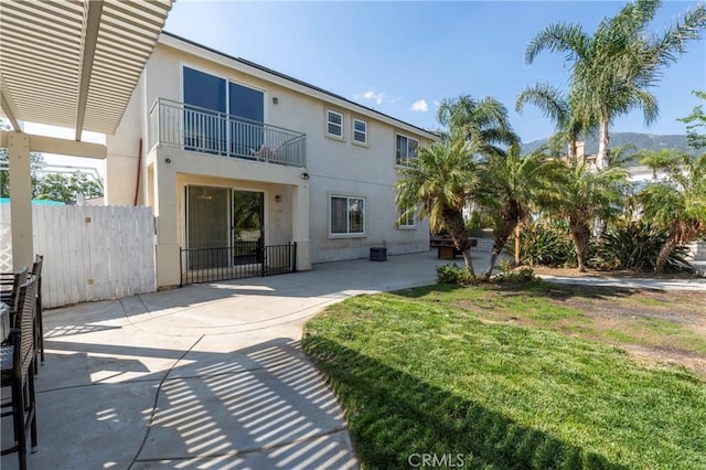 6651 Darling Ln, San Bernardino, CA 92407 - back of house with a yard, a patio area, stucco siding, and fence