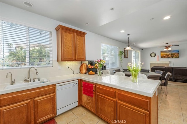 6651 Darling Ln, San Bernardino, CA 92407 - kitchen featuring dishwasher, light tile patterned floors, a sink, open floor plan, and a peninsula