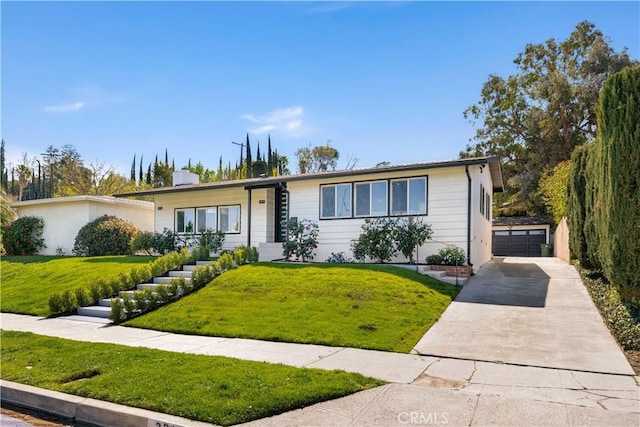 single story home with an outbuilding, a front lawn, and a garage