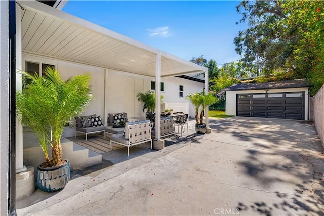 view of patio featuring a garage, an outdoor living space, and an outbuilding