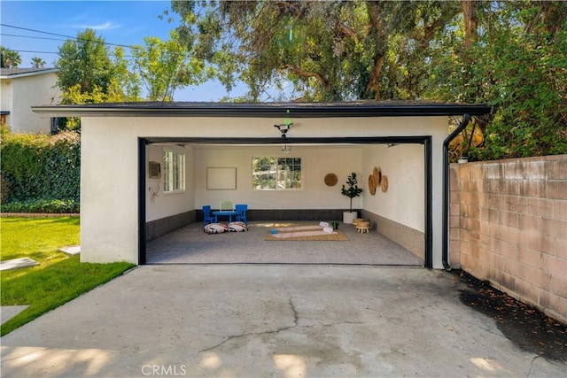 view of outdoor structure with a garage and fence