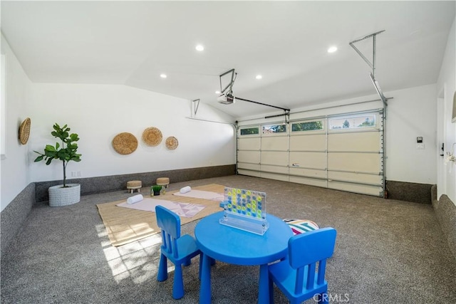 garage with a garage door opener and recessed lighting