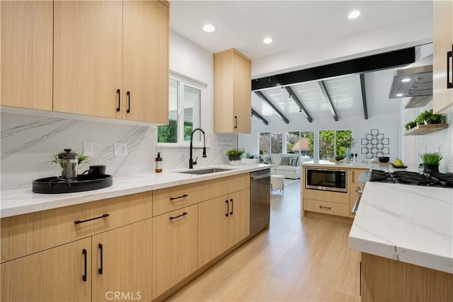 kitchen with built in microwave, light brown cabinets, dishwasher, and a sink