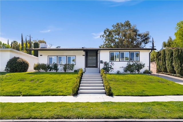 view of front of home with a front lawn