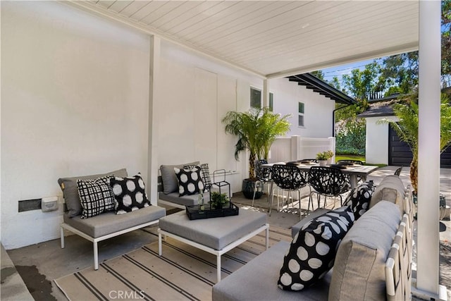 view of patio with an outdoor structure, an outdoor hangout area, and outdoor dining space