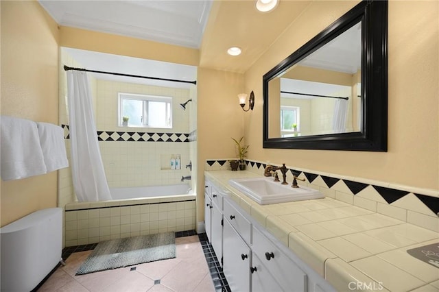 bathroom featuring tiled shower / bath combo, vanity, tile patterned flooring, and crown molding