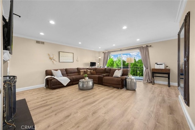 living room with baseboards, crown molding, wood finished floors, and visible vents