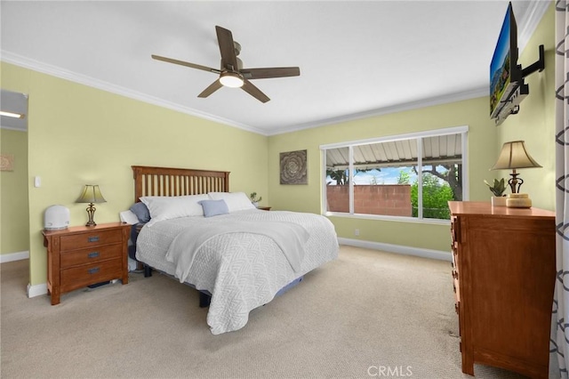 bedroom featuring light colored carpet, baseboards, and crown molding