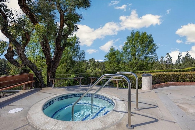 view of swimming pool featuring a community hot tub