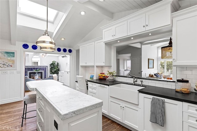 15 N Callecita, Laguna Beach, CA 92651 - kitchen with a sink, a tiled fireplace, decorative backsplash, white cabinets, and recessed lighting