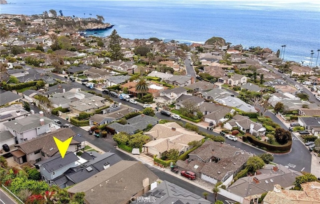 drone / aerial view featuring a residential view and a water view