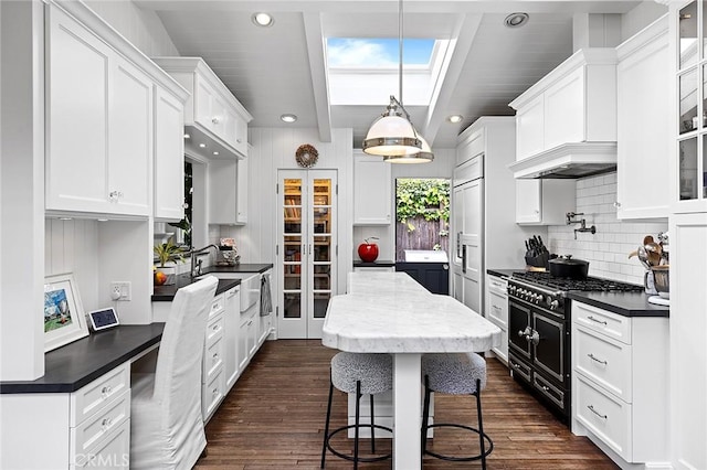 15 N Callecita, Laguna Beach, CA 92651 - kitchen with range with two ovens, white cabinets, dark countertops, backsplash, and recessed lighting
