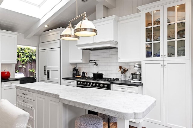 15 N Callecita, Laguna Beach, CA 92651 - kitchen featuring decorative backsplash, white cabinets, glass insert cabinets, paneled refrigerator, and beamed ceiling