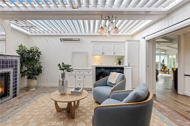 15 N Callecita, Laguna Beach, CA 92651 - living area with a tile fireplace, separate washer and dryer, a chandelier, and baseboards