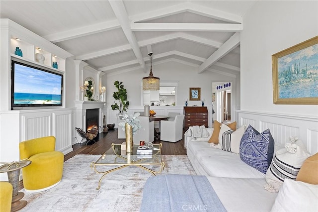 15 N Callecita, Laguna Beach, CA 92651 - living room featuring dark wood finished floors, wainscoting, a warm lit fireplace, and a decorative wall