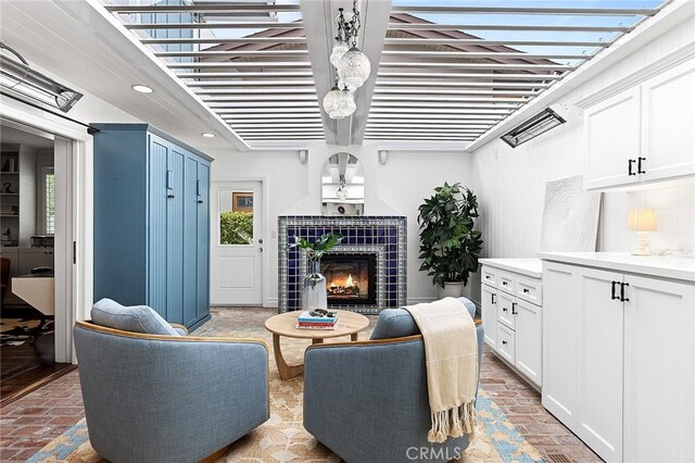 15 N Callecita, Laguna Beach, CA 92651 - living room featuring brick floors, healthy amount of natural light, a tile fireplace, and recessed lighting