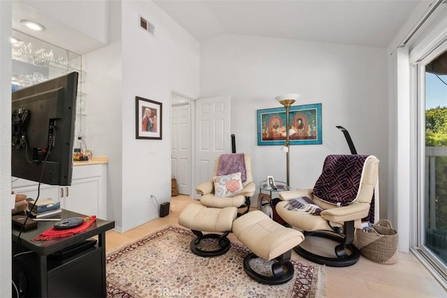 23 Pemberton Pl Unit 121, Laguna Niguel, CA 92677 - living area with lofted ceiling, wood finished floors, and visible vents