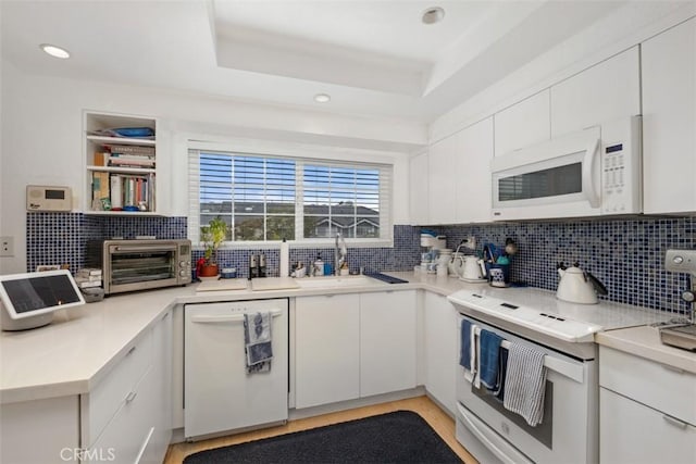 23 Pemberton Pl Unit 121, Laguna Niguel, CA 92677 - kitchen with white appliances, tasteful backsplash, white cabinetry, light countertops, and a toaster