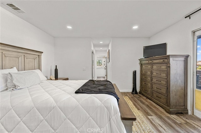 bedroom featuring recessed lighting, visible vents, wood finished floors, and baseboards