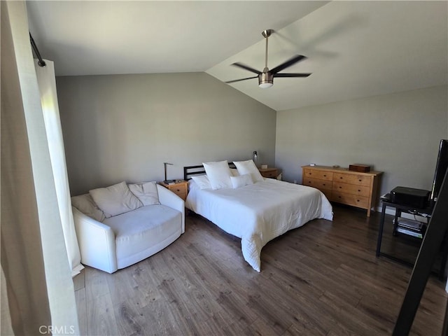 bedroom with vaulted ceiling, a ceiling fan, and wood finished floors
