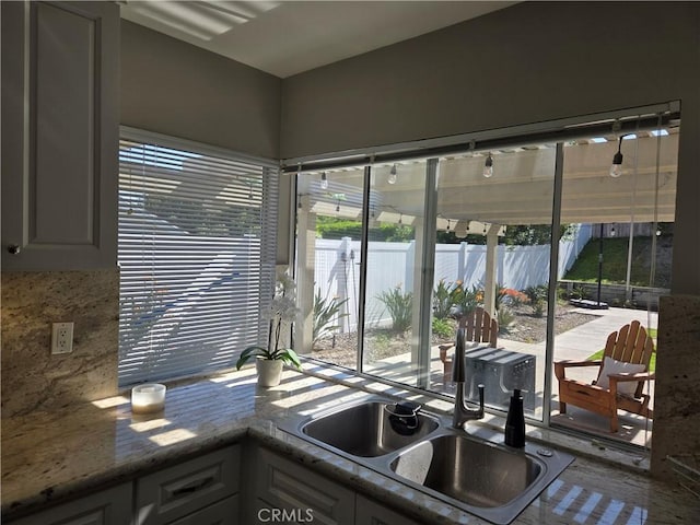 kitchen featuring decorative backsplash and a sink