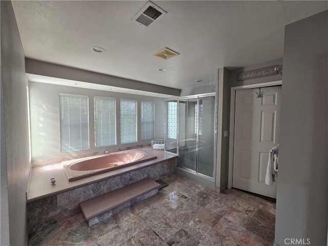full bathroom with a garden tub, visible vents, stone finish floor, and a shower stall
