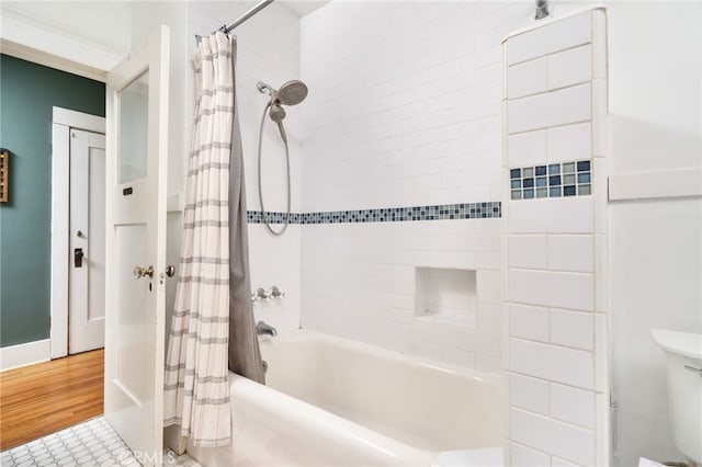 bathroom featuring shower / bath combination with curtain and toilet