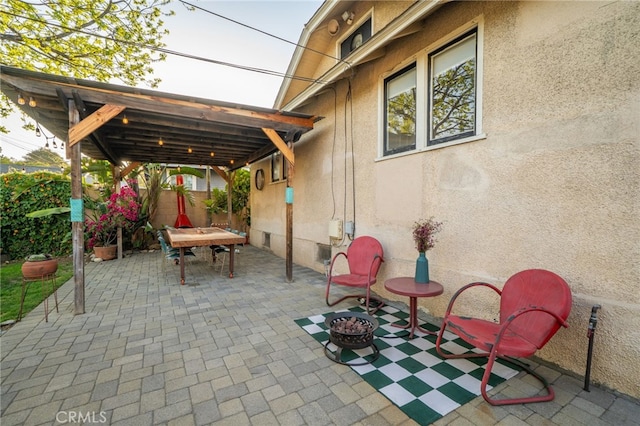 view of patio / terrace with fence, a fire pit, and outdoor dining area