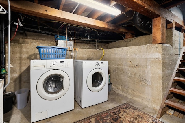 clothes washing area featuring washer and dryer and laundry area