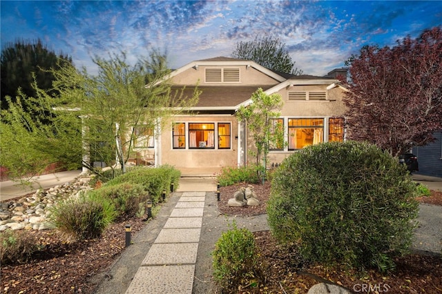 craftsman inspired home with stucco siding