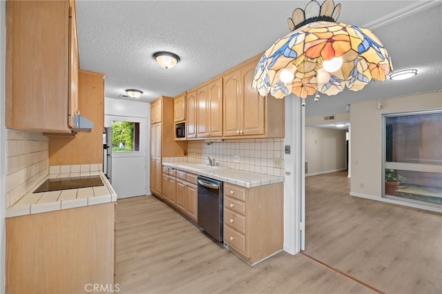 kitchen featuring stainless steel dishwasher, tile countertops, light brown cabinets, and black electric cooktop