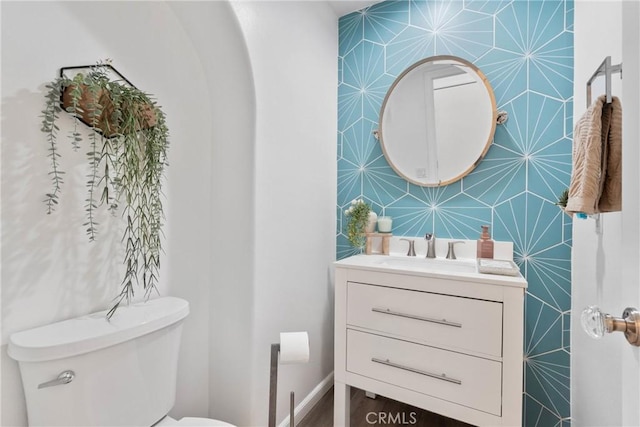 bathroom featuring toilet and vanity