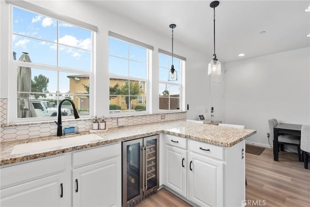 12362 Cottonwood Pl, Santa Fe Springs, CA 90670 - bar featuring wine cooler, a sink, decorative backsplash, light wood-style floors, and recessed lighting