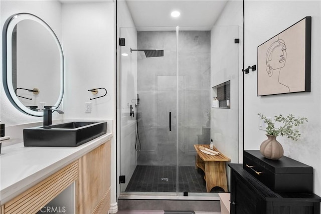 bathroom with recessed lighting, a shower stall, and vanity