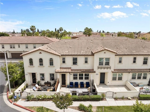 12362 Cottonwood Pl, Santa Fe Springs, CA 90670 - back of property with a gate, a fenced backyard, a patio area, outdoor lounge area, and stucco siding