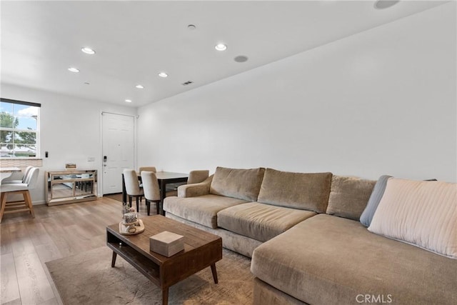living room featuring recessed lighting, visible vents, and light wood-style flooring
