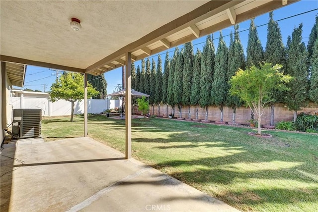 view of yard featuring a gazebo, a fenced backyard, a patio, and central AC unit