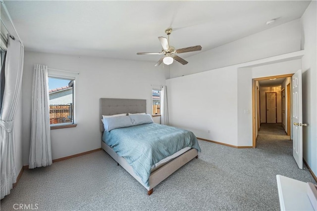 carpeted bedroom featuring baseboards and ceiling fan