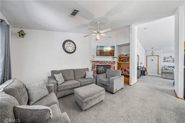 living area featuring light carpet, a brick fireplace, a ceiling fan, lofted ceiling, and visible vents