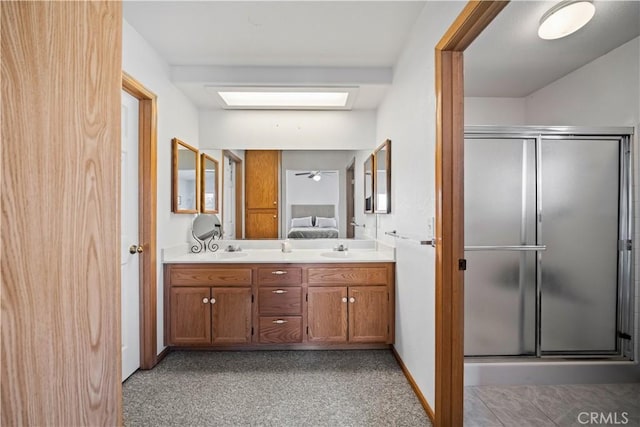 full bathroom with double vanity, a sink, ensuite bathroom, and a stall shower