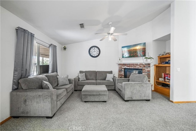 carpeted living area with ceiling fan, a fireplace, baseboards, vaulted ceiling, and visible vents