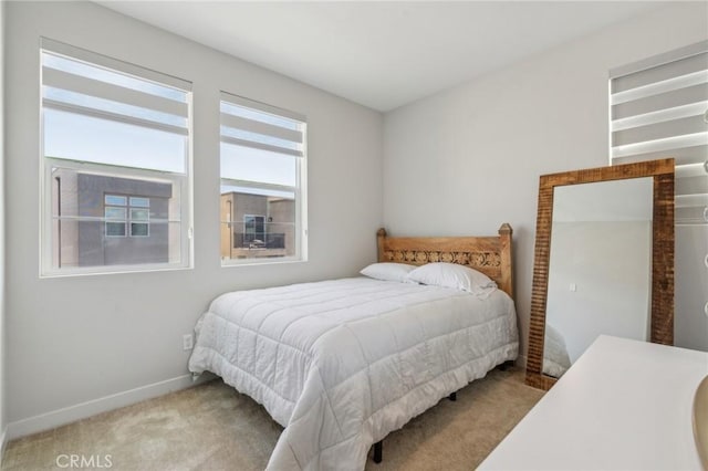 carpeted bedroom featuring baseboards
