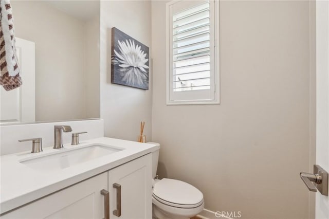half bathroom with toilet and vanity