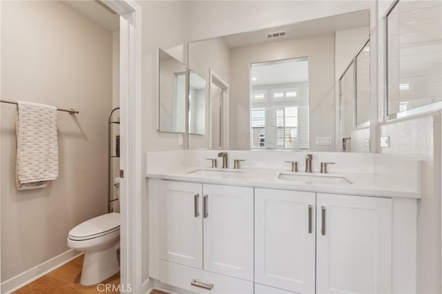 25 Splendor Way, Rancho Mission Viejo, CA 92694 - bathroom featuring toilet, double vanity, a tile shower, and baseboards