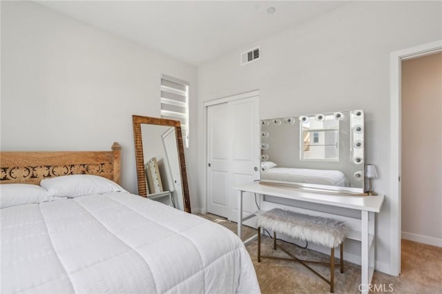 carpeted bedroom featuring baseboards and visible vents