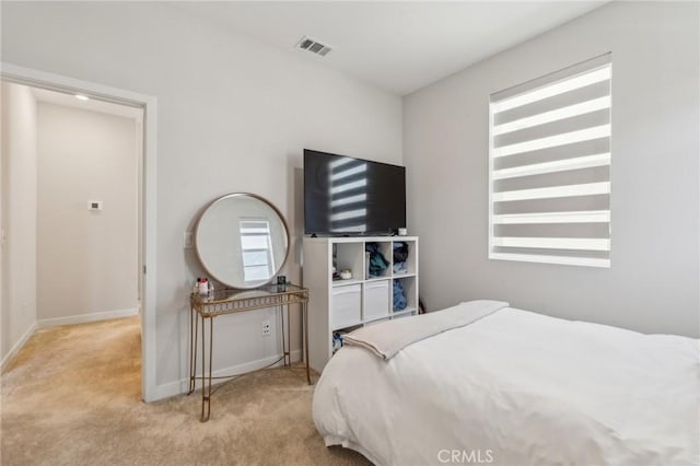 carpeted bedroom with baseboards and visible vents