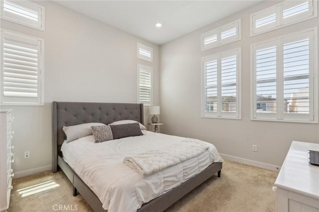 bedroom with light colored carpet, baseboards, and recessed lighting